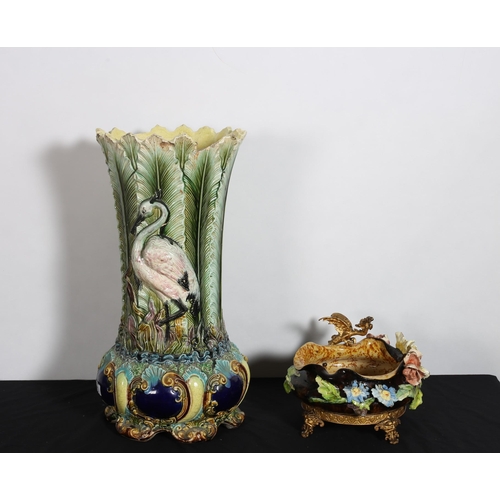 309 - A CONTINENTAL GLAZED POTTERY VASE moulded in relief with foliage and swans on scroll legs 
62cm (h) ... 