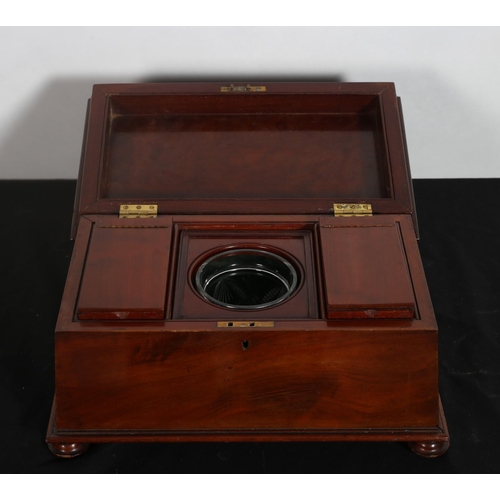 315 - A 19TH CENTURY MAHOGANY TEA CADDY of sarcophagus outline the hinged lid containing lidded compartmen... 