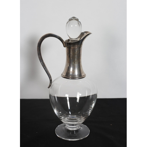 325 - A SILVER TOPPED CLARET JUG with scroll handle and stopper 
30cm (h)