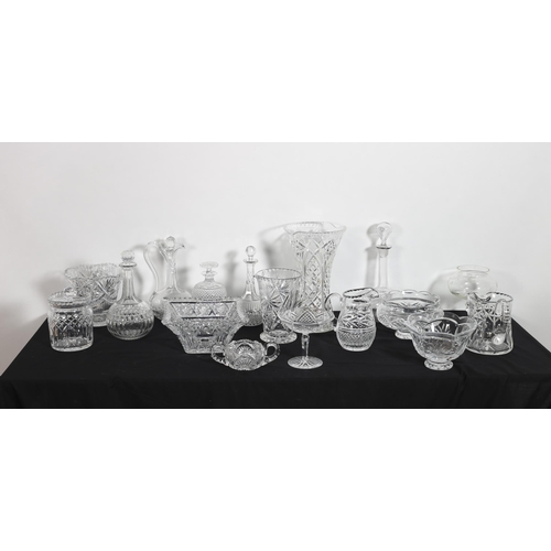 338 - A LARGE COLLECTION OF CUT GLASS to include decanters, jugs, vases, champagne flutes, biscuit barrels... 