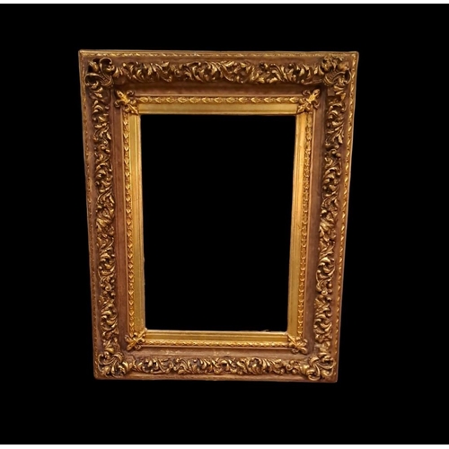 373 - A CONTINENTAL GILT FRAME MIRROR the rectangular plate within a foliate C-scroll frame with fleur de ... 