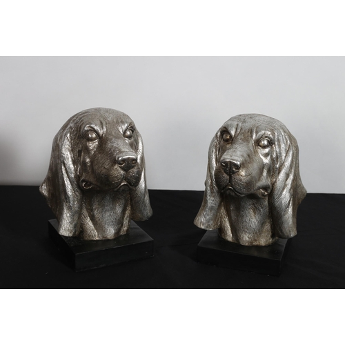 389 - A PAIR OF CONTINENTAL SILVERED AND EBONISED BOOK ENDS each in the form of a dog's head 
20cm (h)