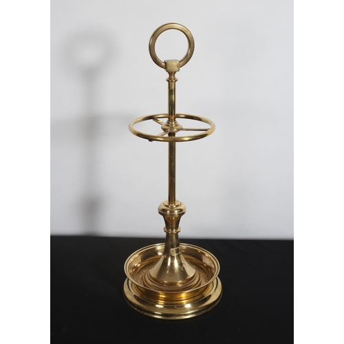 390 - A BRASS FOUR COMPARTMENT STICK STAND of circular form the knopped column above a circular dish with ... 