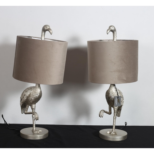 392 - A PAIR OF CONTINENTAL SILVERED TABLE LAMPS each modelled as a flamingo shown standing on a circular ... 