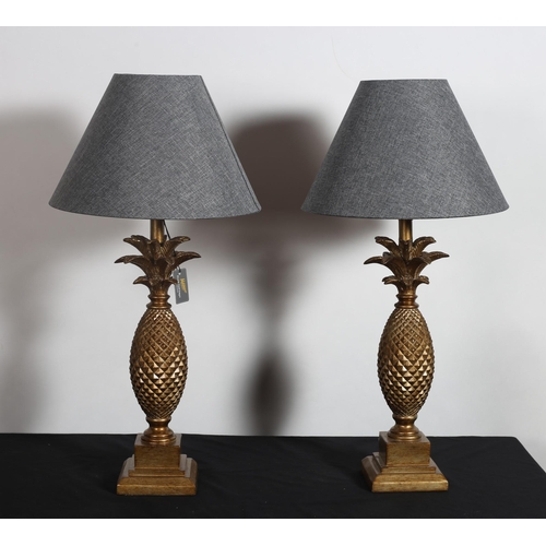 400 - A PAIR OF CONTINENTAL GILT TABLE LAMPS each in the form of a pineapple raised on a square stepped ba... 