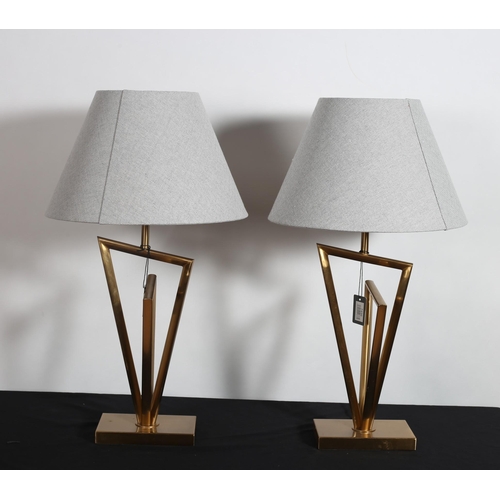 401 - A PAIR OF DESIGNER BRASS TABLE LAMPS each with a tubular column of irregular outline raised on a rec... 