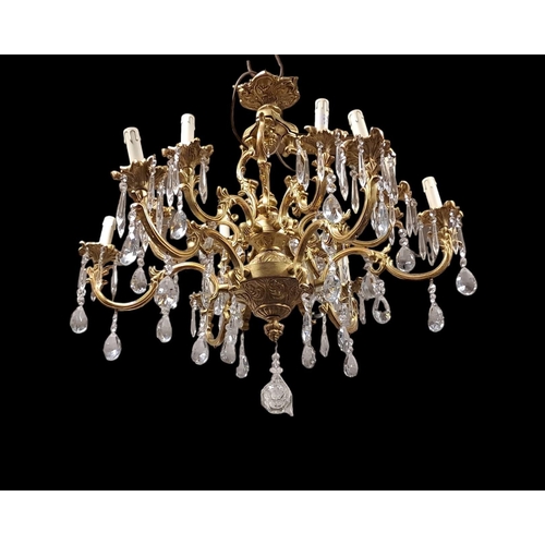 409 - A CONTINENTAL GILT BRASS AND CUT GLASS TEN BRANCH CHANDELIER with foliate cast scroll arms and drip ... 