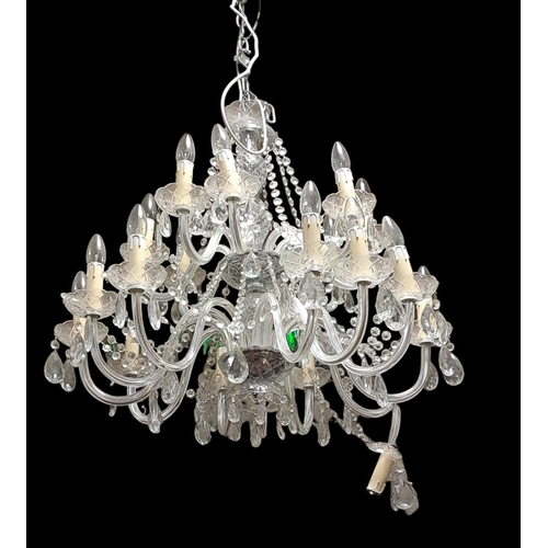 413 - A PAIR OF CONTINENTAL CUT GLASS TWENTY BRANCH CHANDELIERS in two registers hung with faceted chains ... 