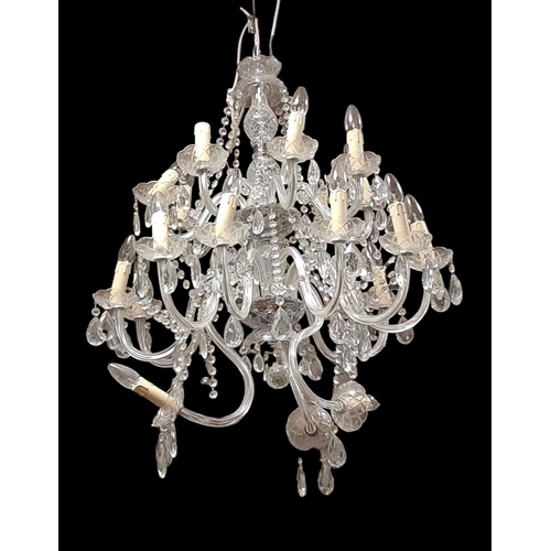 413 - A PAIR OF CONTINENTAL CUT GLASS TWENTY BRANCH CHANDELIERS in two registers hung with faceted chains ... 