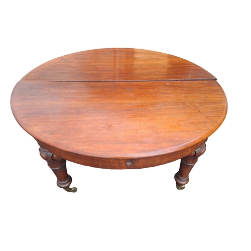 422 - A 19TH CENTURY MAHOGANY TELESCOPIC DINING TABLE of rectangular outline with rounded ends and two loo... 