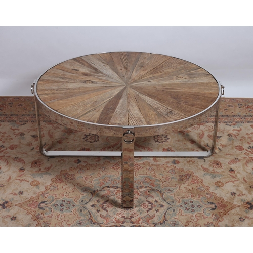 425 - A DESIGNER CHROME AND HARDWOOD COFFEE TABLE of circular outline the shaped top with segmented panel ... 