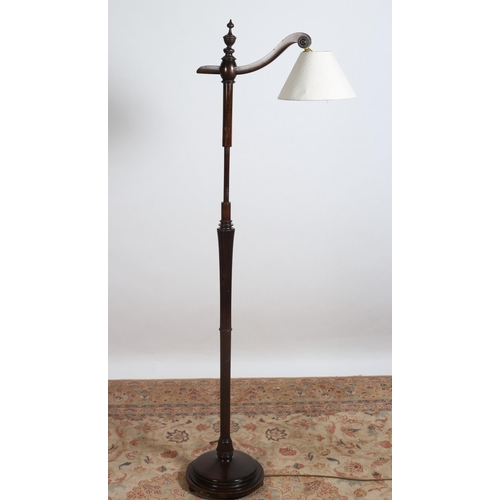 435 - A MAHOGANY FLOOR STANDARD LAMP the reeded and turned column with scroll arm above a circular foot 
1... 