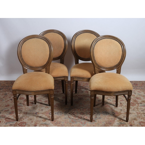 447 - A SET OF FOUR STAINED BEECHWOOD AND UPHOLSTERED DINING CHAIRS each with an oval upholstered back and... 