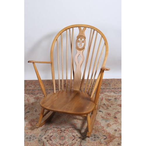 464 - A BEECHWOOD FRAME ROCKING CHAIR the curved top rail with pierced vertical splat and cylindrical barr... 