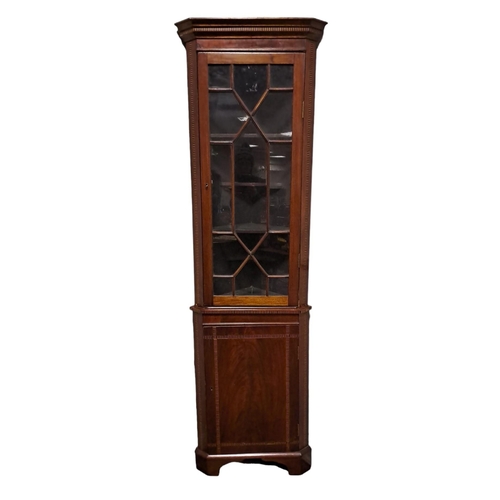 467 - AN EDWARDIAN MAHOGANY AND SATINWOOD INLAID CORNER CABINET the moulded cornice above an astragal glaz... 