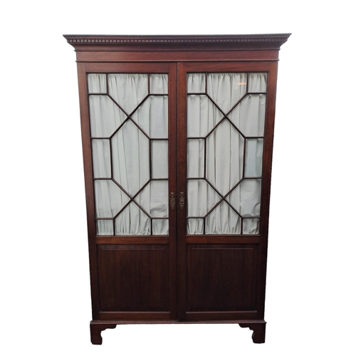 479 - AN EDWARDIAN MAHOGANY DIAMOND DOOR WARDROBE the dentil moulded cornice above a pair of astragal glaz... 