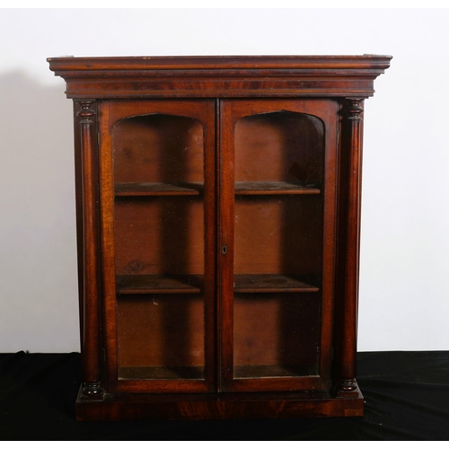 497 - A 19TH CENTURY MAHOGANY MINIATURE BOOKCASE of rectangular outline the moulded cornice above a pair o... 