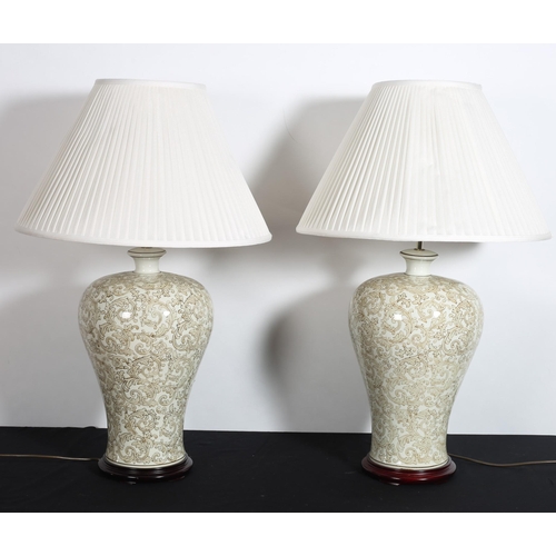 503 - A PAIR OF CHINA TABLE LAMPS each of bulbous tapering form the white ground with stylised flowerheads... 