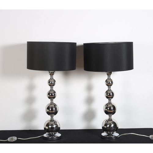 507 - A PAIR OF CHROME TABLE LAMPS each with knopped column raised on a circular spreading foot with shade... 