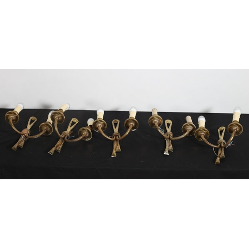 513 - SEVEN GILT BRASS TWO BRANCH WALL LIGHTS each with a ribbon tied back plate issuing two roped scroll ... 