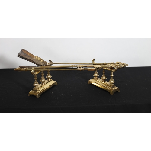 515 - TWO BRASS FENDERS together with A SET OF THREE BRASS FIRE IRONS and FIRE DOGS (7)