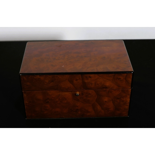 520 - A SIMULATED BURR WALNUT JEWELLERY CASKET the rectangular hinged top with removable trays and compart... 