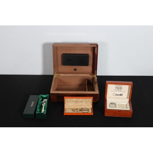 521 - A WALNUT HUMIDOR and a plated cigar cutters (2), a limited edition model of Colibri 1928 lighter wit... 