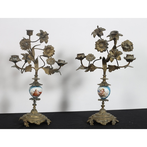 531 - A PAIR OF CONTINENTAL GILT BRASS AND PORCELAIN THREE BRANCH CANDELBRA with flowerhead and foliate de... 