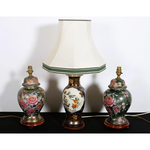 571 - A PAIR OF CHINA TABLE LAMPS each of baluster form the green floral ground raised on a hardwood stand... 