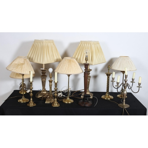 582 - A PAIR OF CONTINENTAL GILT TABLE LAMPS each with square tapering column above a spreading foot with ... 