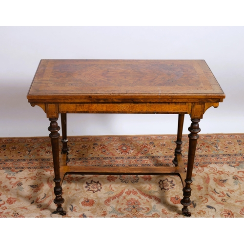 62 - A 19TH CENTURY WALNUT CROSSBANDED FOLDOVER CARD TABLE the shaped hinge top with baize lined interior... 