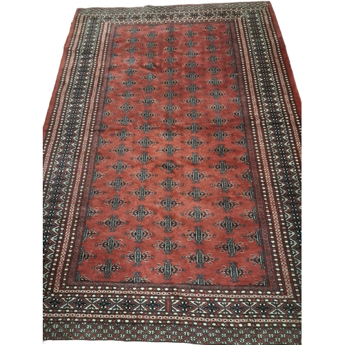 622 - A BOKHARA WOOL RUG the wine ground with central panel filled with stylised foliage within a rectangu... 