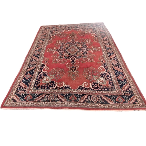 623 - A KESHAN WOOL RUG the multicoloured ground with central panel filled with flowerheads and foliage wi... 