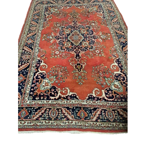 623 - A KESHAN WOOL RUG the multicoloured ground with central panel filled with flowerheads and foliage wi... 