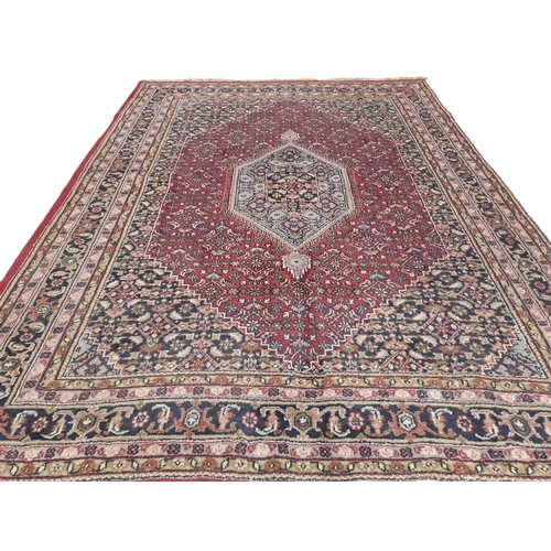 624 - A BIDJAR WOOL RUG the wine, indigo and beige ground with central panel filled with stylised flowerhe... 