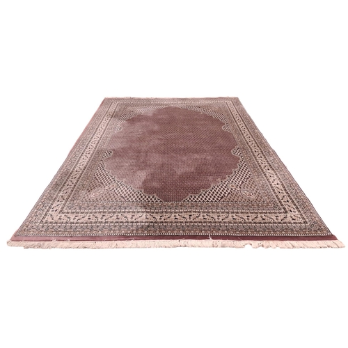 625 - A SAROUK MIR WOOL RUG the light pink and beige ground with central floral panel filled with stylised... 