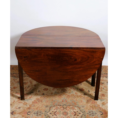 64 - A GEORGIAN MAHOGANY DROP LEAF TABLE the oval hinged top raised on square moulded legs
72cm (h) x 43c... 