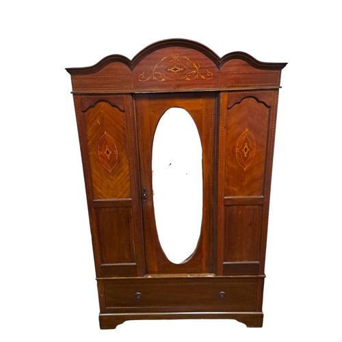 70 - (en suite to previous lot) AN EDWARDIAN MAHOGANY AND SATINWOOD INLAID WARDROBE the rectangular arche... 