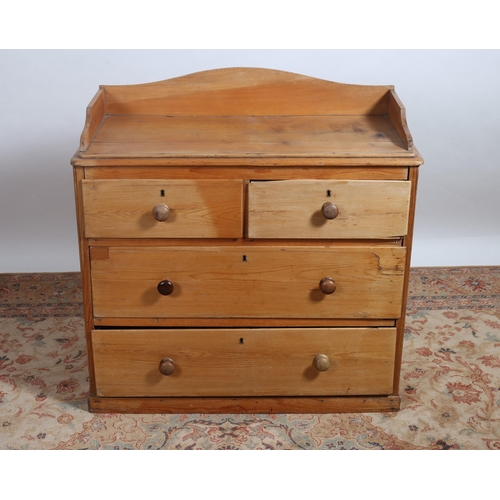 71 - A VICTORIAN PINE CHEST of rectangular outline the shaped top with moulded three quarter gallery abov... 