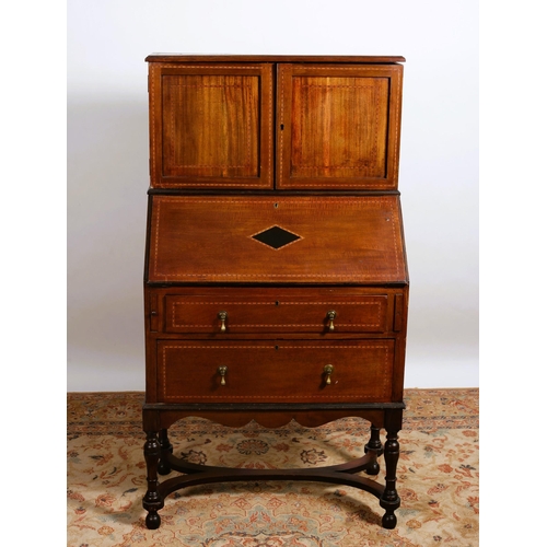 75 - A VINTAGE MAHOGANY INLAID BUREAU the superstructure with cupboards containing stationery compartment... 