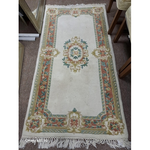 798 - THREE CHINESE WOOL RUGS the white ground with central floral panel within a conforming border 
198cm... 