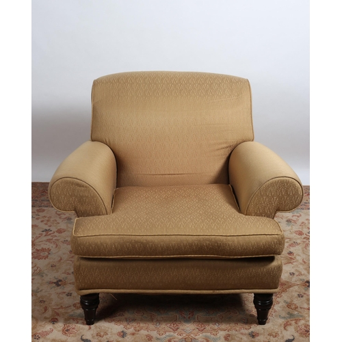 84 - A VICTORIAN STYLE UPHOLSTERED ARMCHAIR with roll over back and arms with loose cushion on baluster l... 