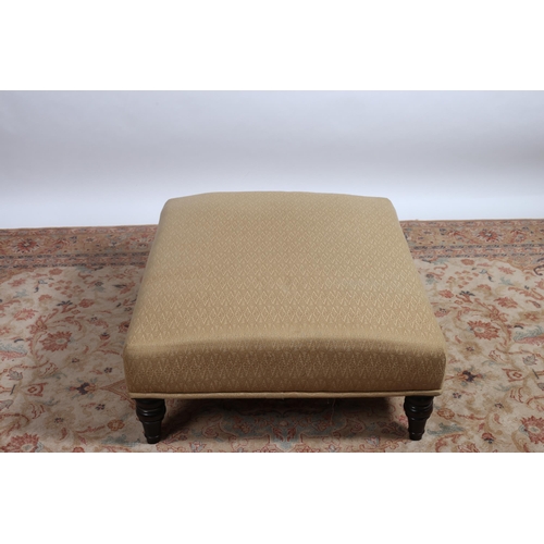 84 - A VICTORIAN STYLE UPHOLSTERED ARMCHAIR with roll over back and arms with loose cushion on baluster l... 