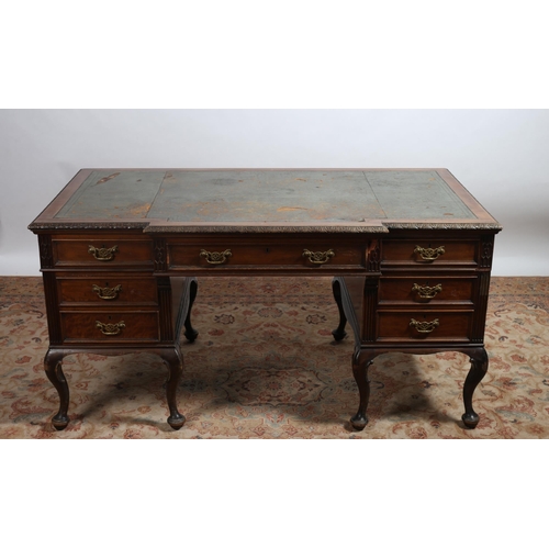 60 - A CHIPPENDALE STYLE 19TH CENTURY MAHOGANY DESK of breakfront outline the shaped top with tooled leat... 