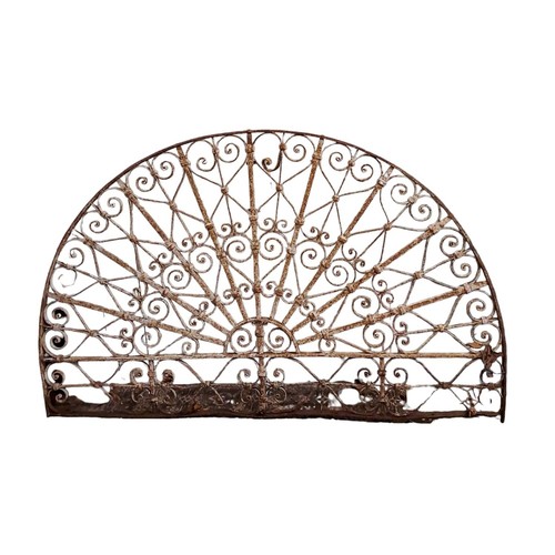 696 - A WROUGHT IRON FAN LIGHT of demi lune outline with scroll and cylindrical barring 
88cm (h) x 163cm ... 