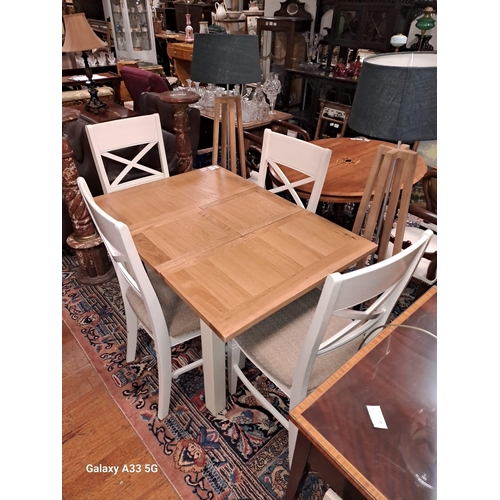 195 - A BEECHWOOD AND PAINTED FIVE PIECE DINING ROOM SUITE comprising four chairs each with a curved top r... 