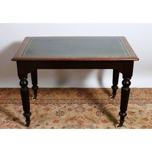 3 - A VINTAGE OAK WRITING TABLE of rectangular outline the shaped top with tooled leather inset above a ... 