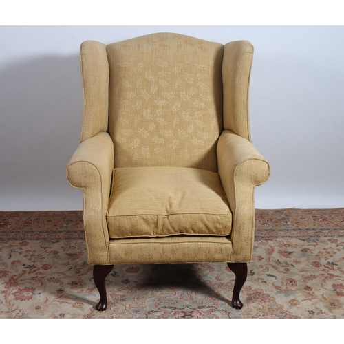 48 - A MAHOGANY AND UPHOLSTERED WING CHAIR with scroll over arms and loose cushion on cabriole legs with ... 