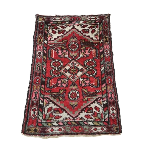 596 - THREE SMALL TRIBAL WOOL RUGS 
Larger 166cm (l) x 108cm (w)
One 155cm (l) x 55cm (w) 
Smaller 83cm (l... 