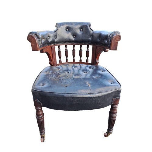 717 - AN EDWARDIAN MAHOGANY UPHOLSTERED TUB SHAPED LIBRARY ARMCHAIR the buttoned upholstered back and seat... 